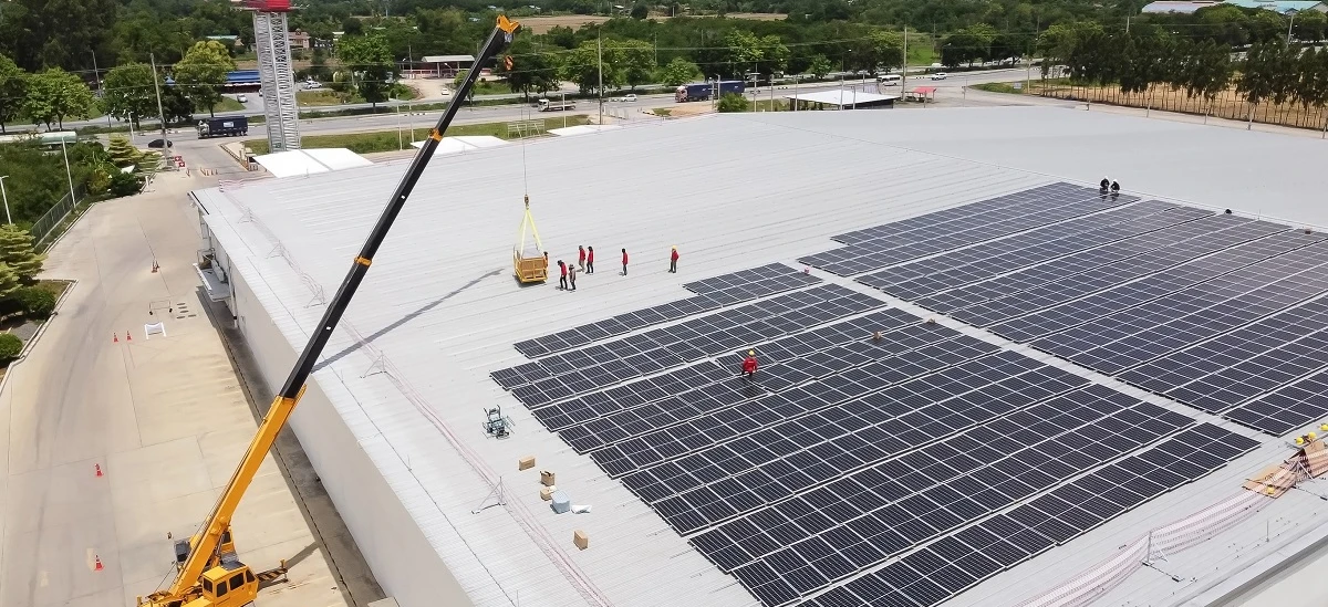 A steel frame structure with solar panels being installed, representing the construction of a solar power system. Harnessing energy from the sun for sustainable power generation.